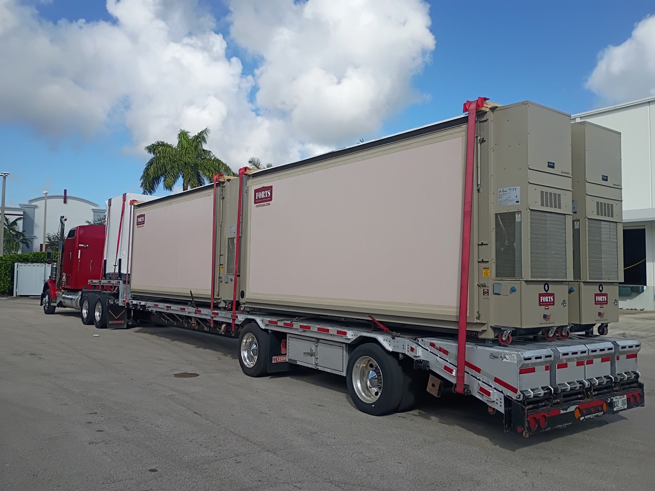 Four folded FORTS 38 buildings secured on a flatbed trailer
