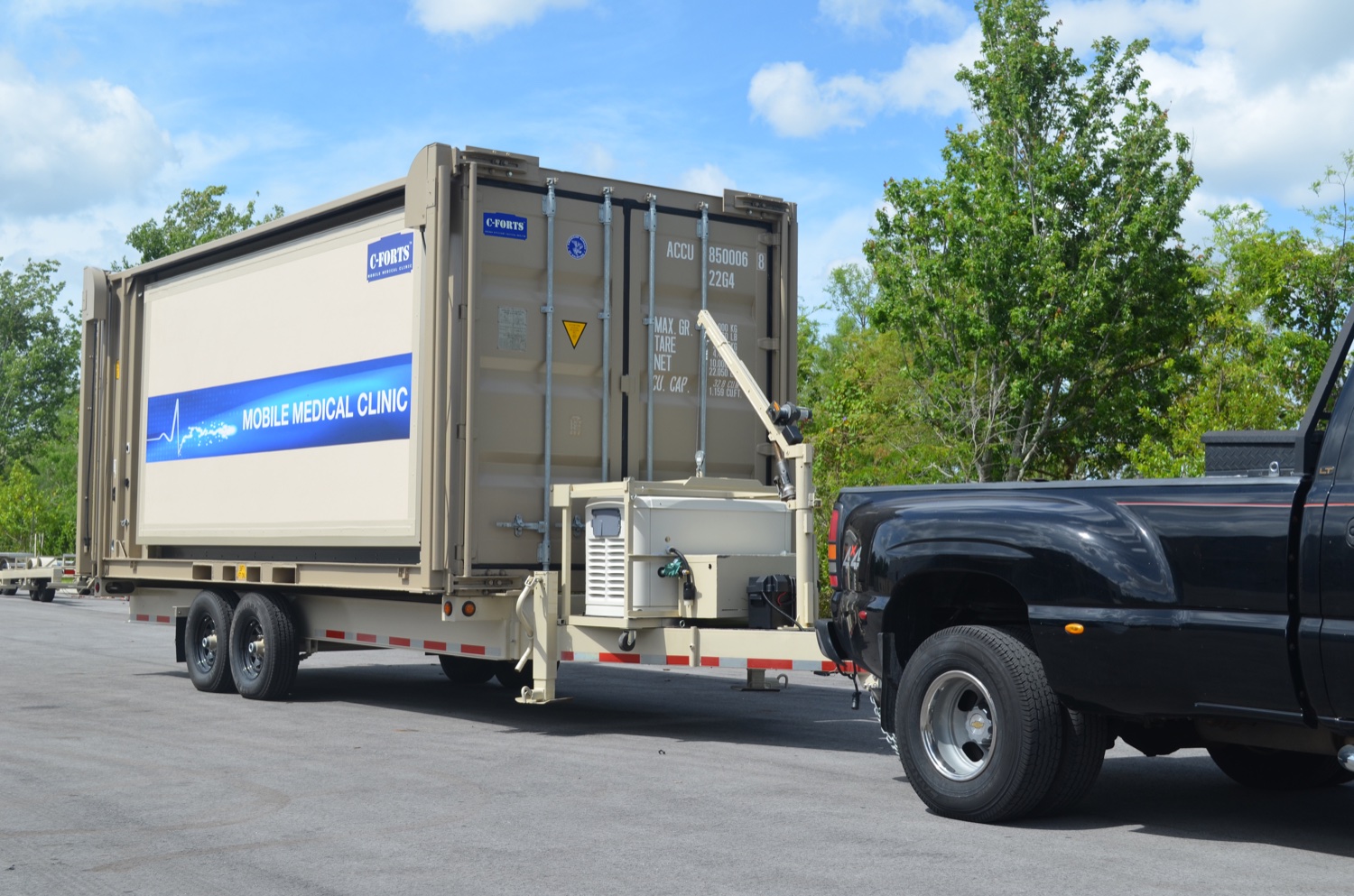 C-FORTS mobile medical clinic packed on a Mobilizer trailer behind a pickup truck