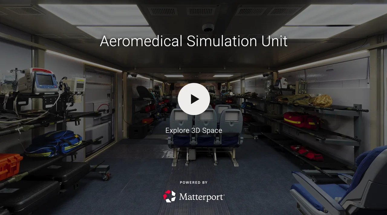 Interior of an aeromedical simulation unit with medical equipment, chairs, and medical bags, used for emergency training and practice.