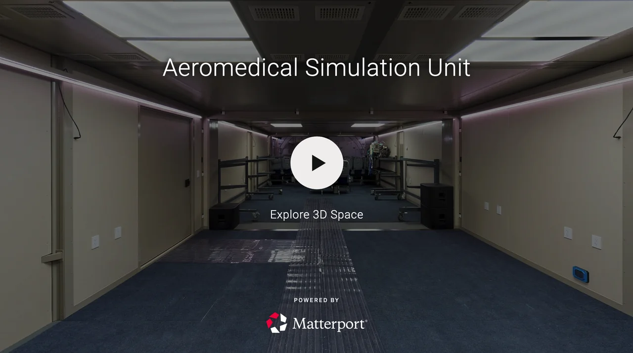 Virtual tour of an aeromedical simulation unit featuring a spacious room with seating and equipment at the far end, labeled 'Aeromedical Simulation Unit'.