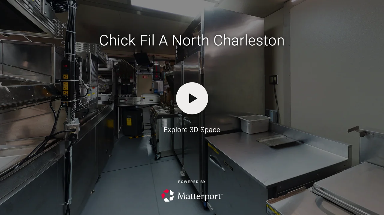 Interior of a Chick-fil-A restaurant kitchen with stainless steel appliances and counters, including cooking equipment, storage, and cleaning supplies.