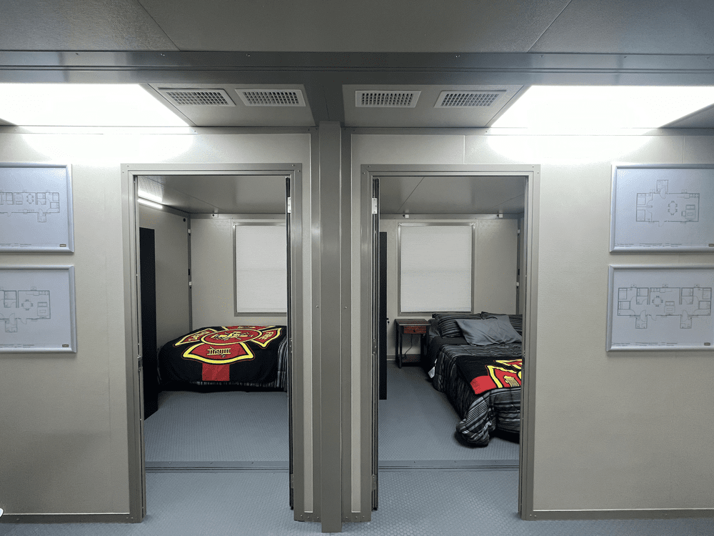 Two furnished sleeping rooms in an example temporary fire station