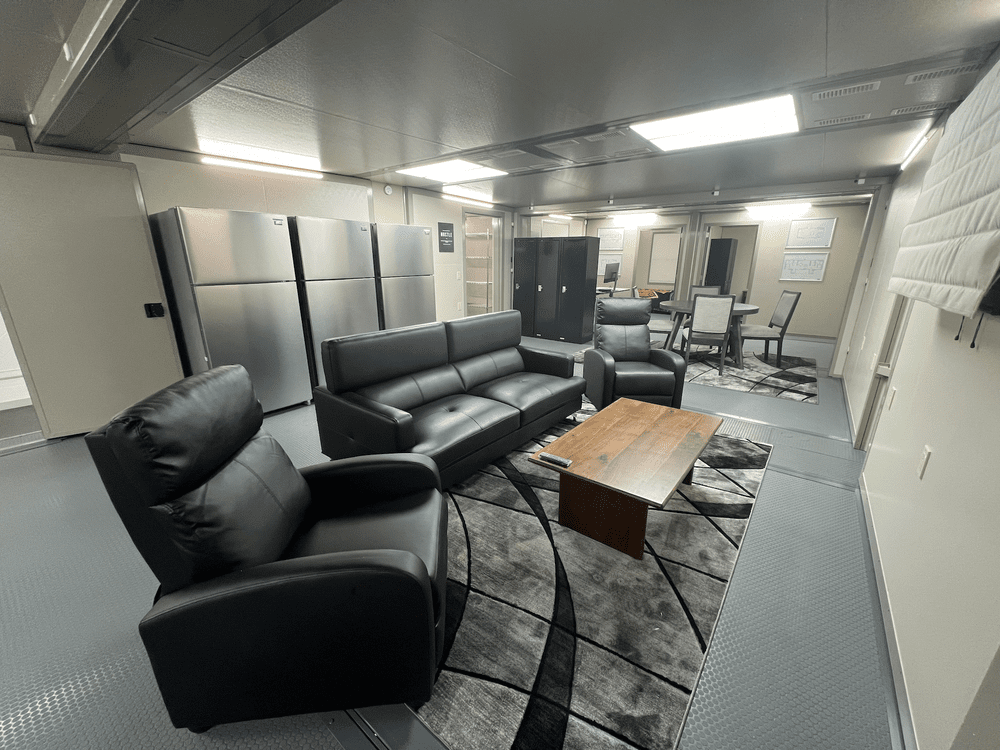 Actual temporary fire-station day room with lounge seating and a dining table