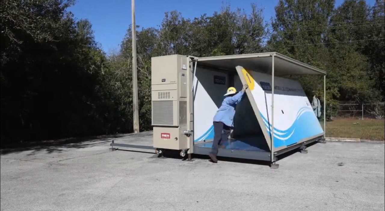 Tampa Electric crew opening the wall of a FORTS 38 shelter